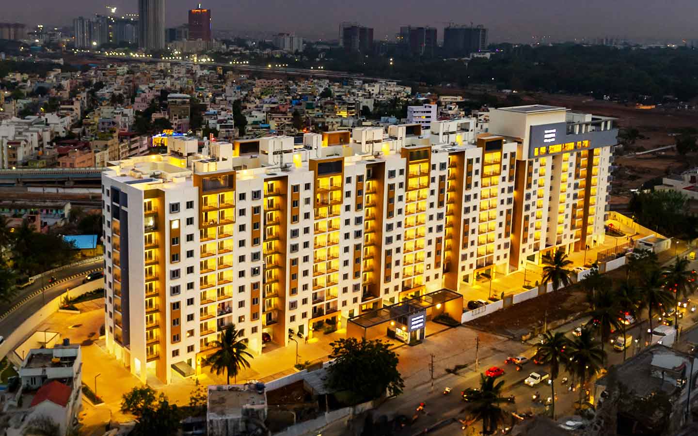 Aerial night view of Renaissance Reserva apartment towers lit up